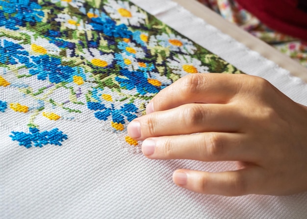 Hands embroidering a floral motif